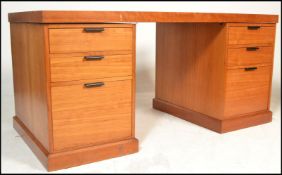 A retro teak wood Danish twin pedestal antique style desk, flared teak top over twin matching