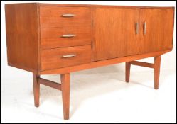 A vintage mid 20th Century Danish influence sideboard having a bank of three drawers beside twin
