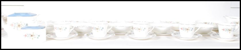 A Royal Doulton part tea service in the Pastorale pattern. Model H5002. The set comprising, cups,