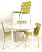 A 20th Century circular white dining table together with a set of four contemporary dining chairs in