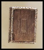 An unmarked silver vinaigrette of rectangular form with engraved decoration having hinged lid
