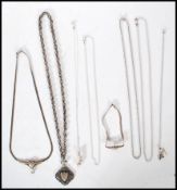 A group of silver necklace chains and pendants to include a rolo chain, a triple link cross over