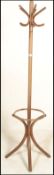 A 20th century bentwood coat stand in the manner of Thonet. Shaped legs to base with hooks atop.