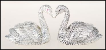 A pair of 925 silver plate salt and pepper table condiments in the form of finely detailed swans