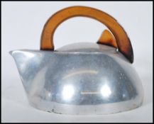 A vintage 20th Century polished stove top kettle by Piquot ware, teak wood handle to the top with