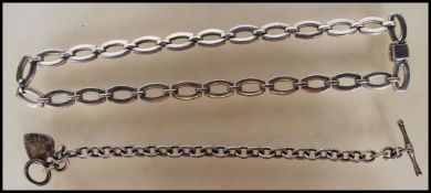 A silver hallmarked link bracelet having a heart pendant with a T-bar clasp. Together with a