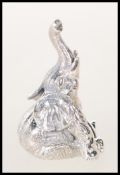 A stamped sterling silver figure in the form of a elephant seated raising his trunk. Weighs 17.5g