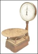 A set of early 20th Century Salter spring balance grocers scales, gilt finish with circular dial