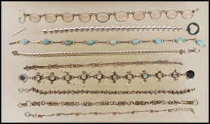 A selection of silver bracelets to include a translucent white stone cabochon bracelet, a flat