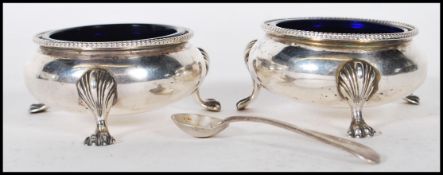A pair of 19th Century Victorian silver hallmarked table salt condiments of round form having