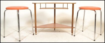 A pair of vintage stools having orange crackle leather round pad seats raised on four chromed