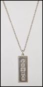 A silver ingot pendant hallmarked for Sheffield 1977 on a belcher link silver chain with a spring
