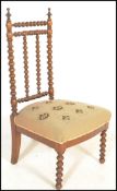 A 19th Century Victorian bobbin framed nursing chair having a stick back with stuffed needlework