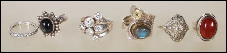 A collection of five silver 20th Century dress rings, each ring of different design to include a