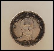 A China 1926 Dollar Type II Sun Yat-sen Silver Yuan coin having the head facing front with two