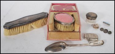 A collection of silver hallmarked items to include cut glass pot with silver lid, silver