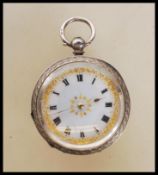 A 20th century continental silver fob pocket watch having a white enamelled face with gilt floral