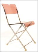 A retro mid 20th Century 1960's folding chair. The chair having a metal frame with a smoked brown