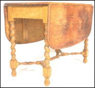 A 19th Century Victorian scrubbed oak Arts and Crafts drop leaf dining table, raised on barley twist