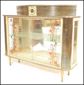 A vintage retro mid 20th Century Kitsch cocktail / display cabinet, glazed floral printed sliding
