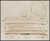 A selection of silver bracelets to include a spacer bracelet having a lobster claw clasp, oval and