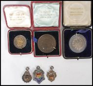 A collection of Bristol local interest medals awarded to a J Hearle to include three silver fob