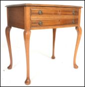 A 20th Century mahogany free standing cutlery canteen bow fronted side table being raised on four