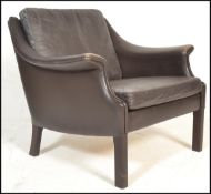 A late 20th century retro vintage Danish easy lounge chair / armchair having dark brown leather