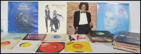 A collection of vinyl long play LP vinyl record albums and 45rpm 7