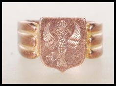 A hallmarked 9ct gold signet ring having an armorial crest head engraved with a crest on reeded