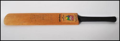 A Gloucestershire Country Cricket Club cricket bat signed by the team of 1985  including Richard