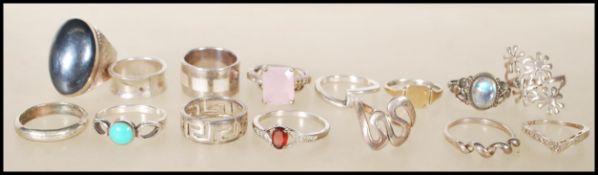 A group of sixteen silver rings to include Greek key design, one with flower heads, twist style,