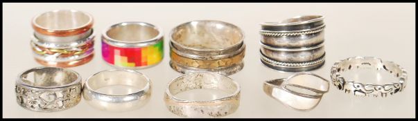 A selection of silver rings to include an elephant eternity ring, a banded rope twist ring, a mother
