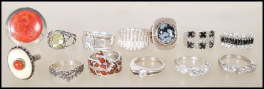 A selection of stamped 925 rings to include an openwork ring set with an oval cut green stone, CZ