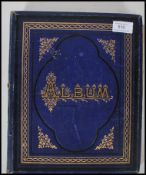 A 19th century Victorian album having blue boards with gilt tooling. The album comprising decoupage,