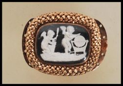 A Regency gold clasp having a central glazed panel with a sulphide panel depicting cherubs
