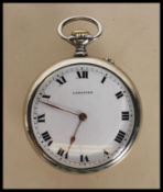 A hallmarked 9ct yellow gold ladies dress set with a central green stone with a halo of white