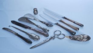 A small group of mostly silver handled flatware and other items to include silver handle button hook