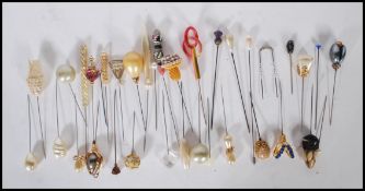 An assortment of vintage 20th Century hat pins to include a Scottish thistle finial hat pin,
