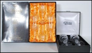 Waterford & Bohemia crystal - A cased set of two Waterford cut wine glass / goblets having faceted