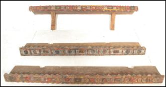 A set of three 20th Century vintage wooden Moroccan shelves having applied coloured mouldings to the