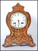 An early 20th Century mahogany cased balloon mantel clock having a mahogany case inlaid with satin