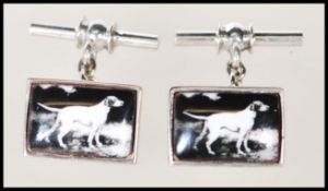 A pair of stamped 925 silver cufflinks having enamelled panels depicting dogs. Gross weight 10.3g.