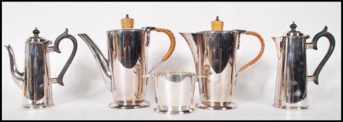 An early 20th Century Walker and Hall silver plated coffee pot having a turned wooden finial to