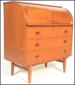 A retro 20th Century Teak wood barrel top bureau having a fully appointed interior over drawers