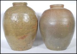 A pair of early 20th Century large floor standing stoneware pickle / olive jars of conical form with