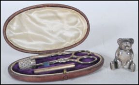 A 20th Century silver sewing kit set within an oval leatherette box with a velvet lined interior
