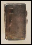 A silver hallmarked cigarette case with engine turned decoration and plain cartouche. Hallmarked for