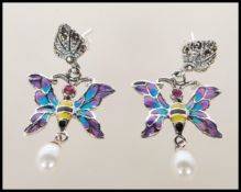A pair of silver and enamel set drop earrings in the form of butterfly's having plique a jour
