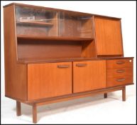 A retro 20th Century teak wood highboard sideboard credenza, being raised on square supports
